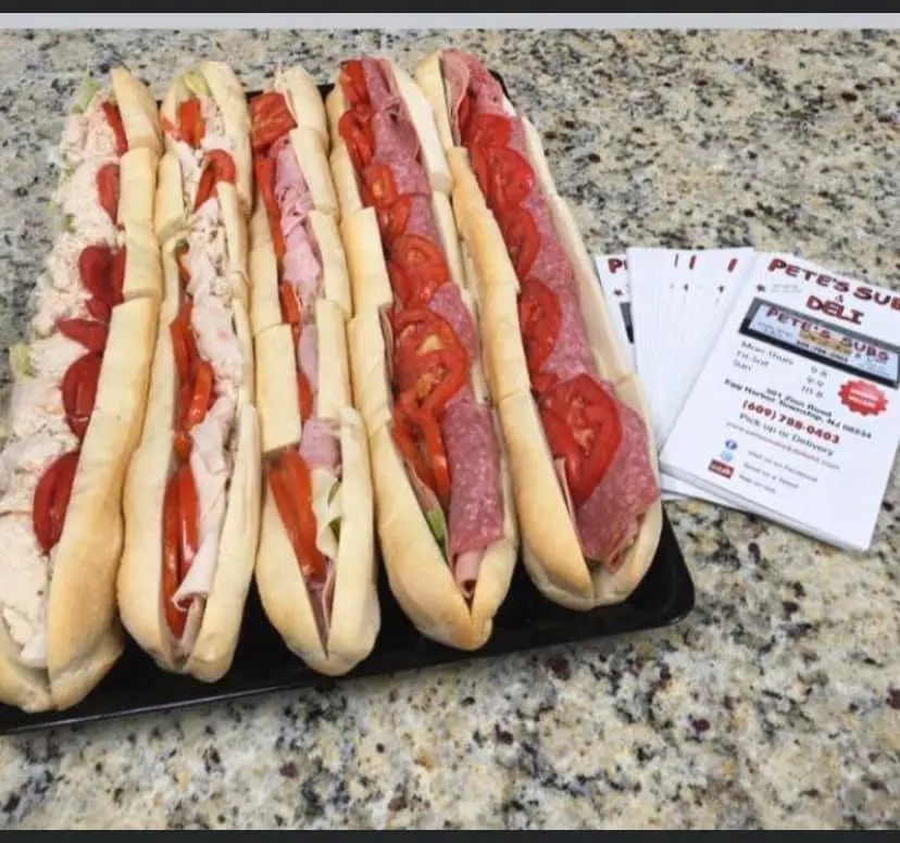 Several of Pete's cold subs arranged on a tray at the shop
